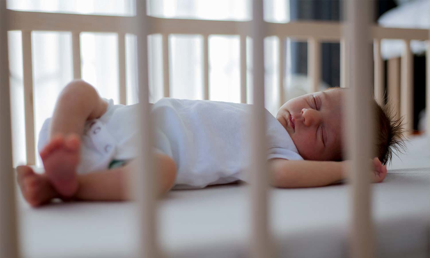 Baby sleeping in cot
