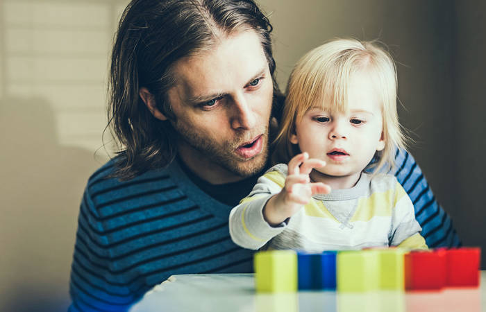 Father and child talking while playing