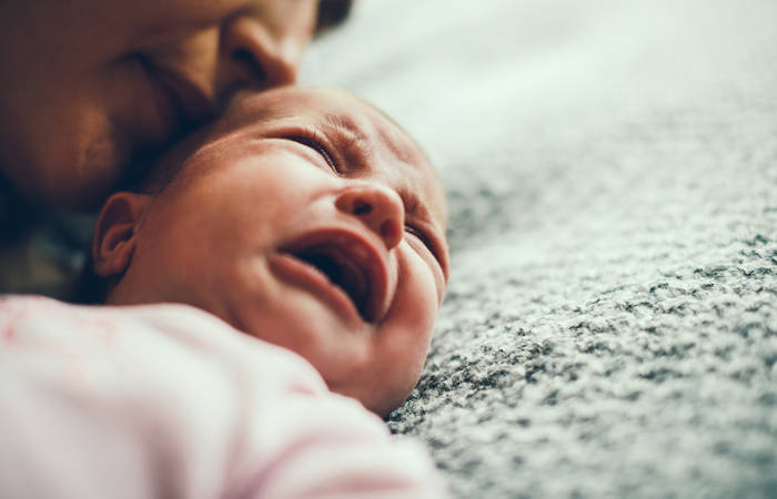 Mother calming her crying baby girl