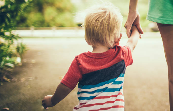 Woman and child holding hands