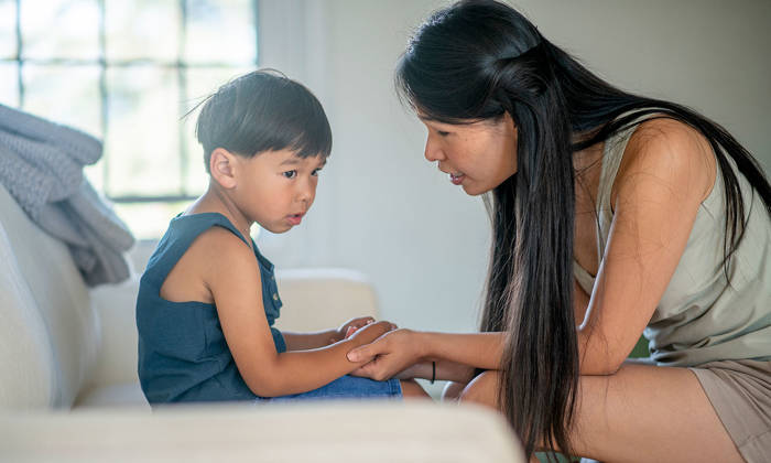 A boy and mother hold hands
