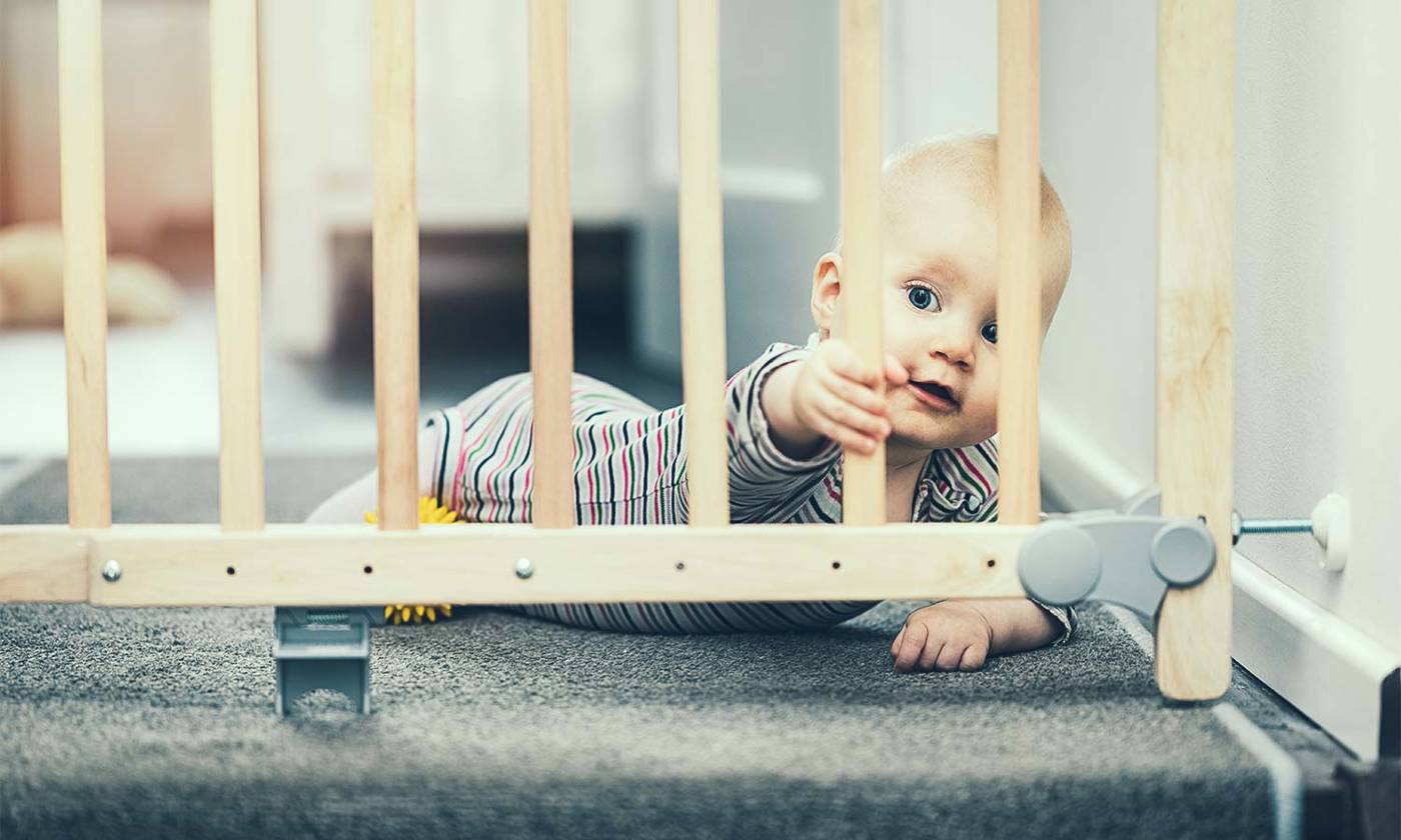 Baby behind a safety gate