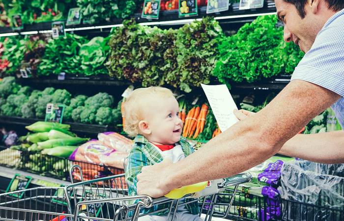 Father and child grocery shopping