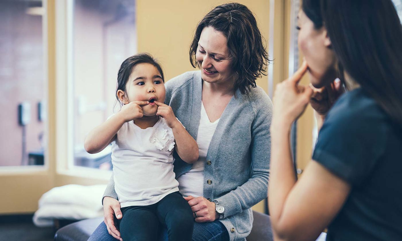 Speech therapist works with kindergarten aged girl
