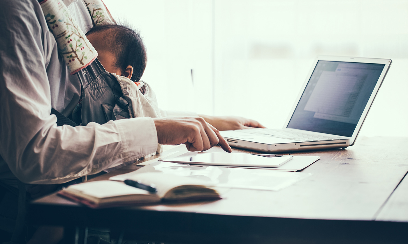 Father with baby working at home