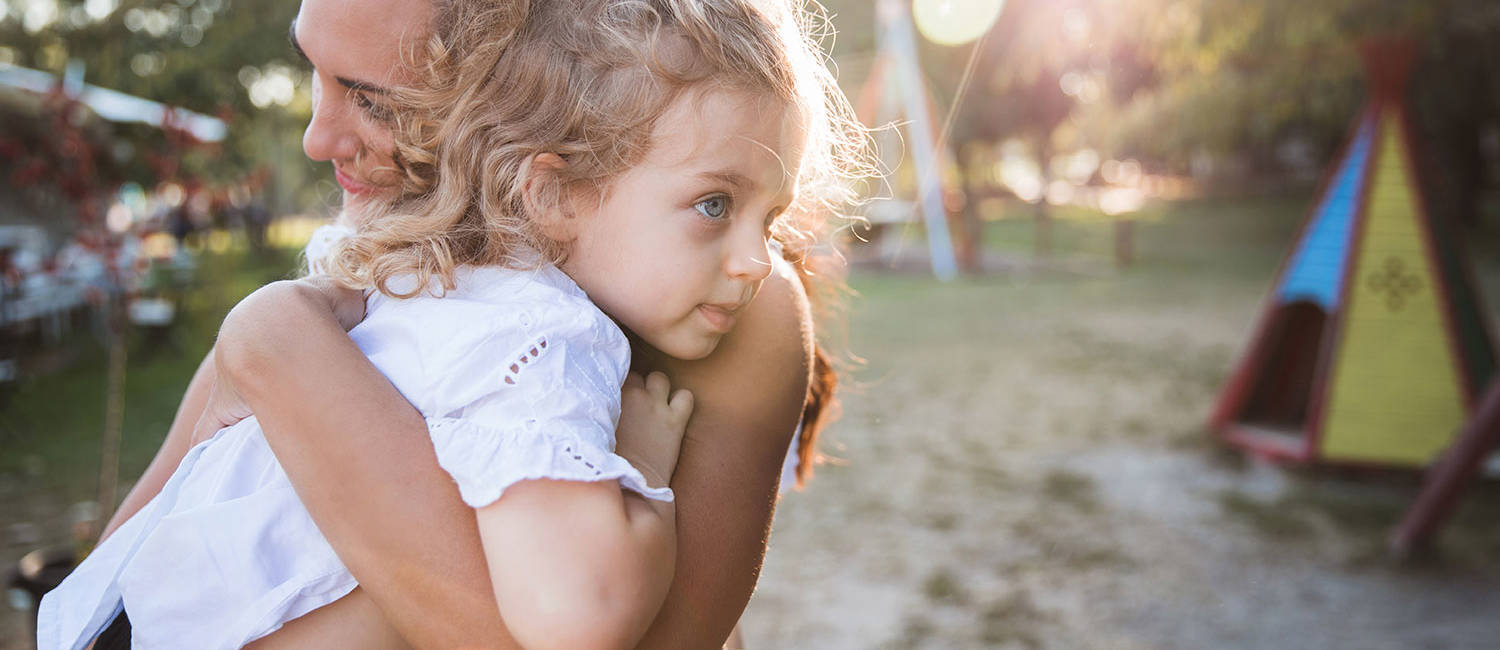 Woman hugging her frightened daughter