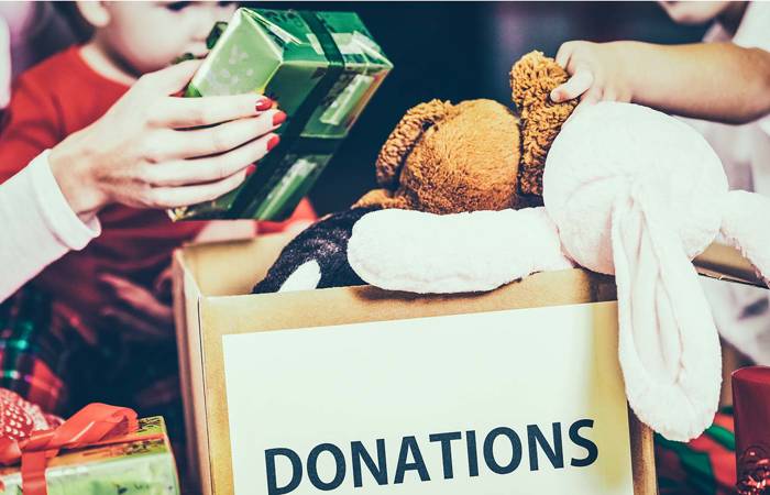 Family donating gifts and toys to charity for Christmas holiday