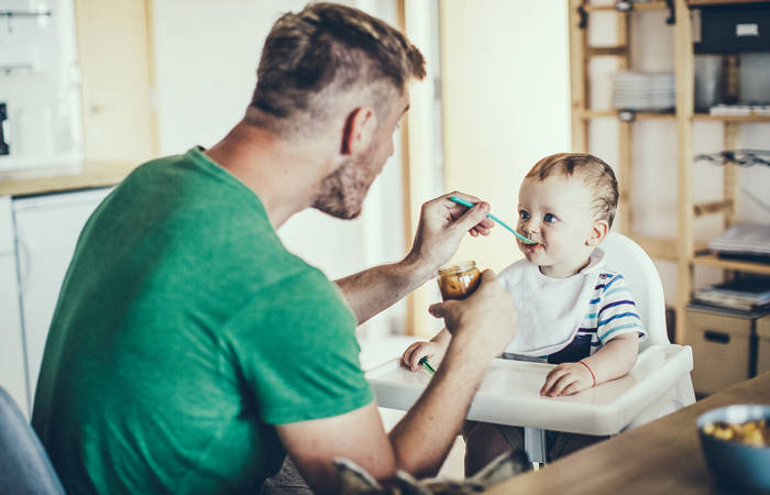 Father feeding an infant