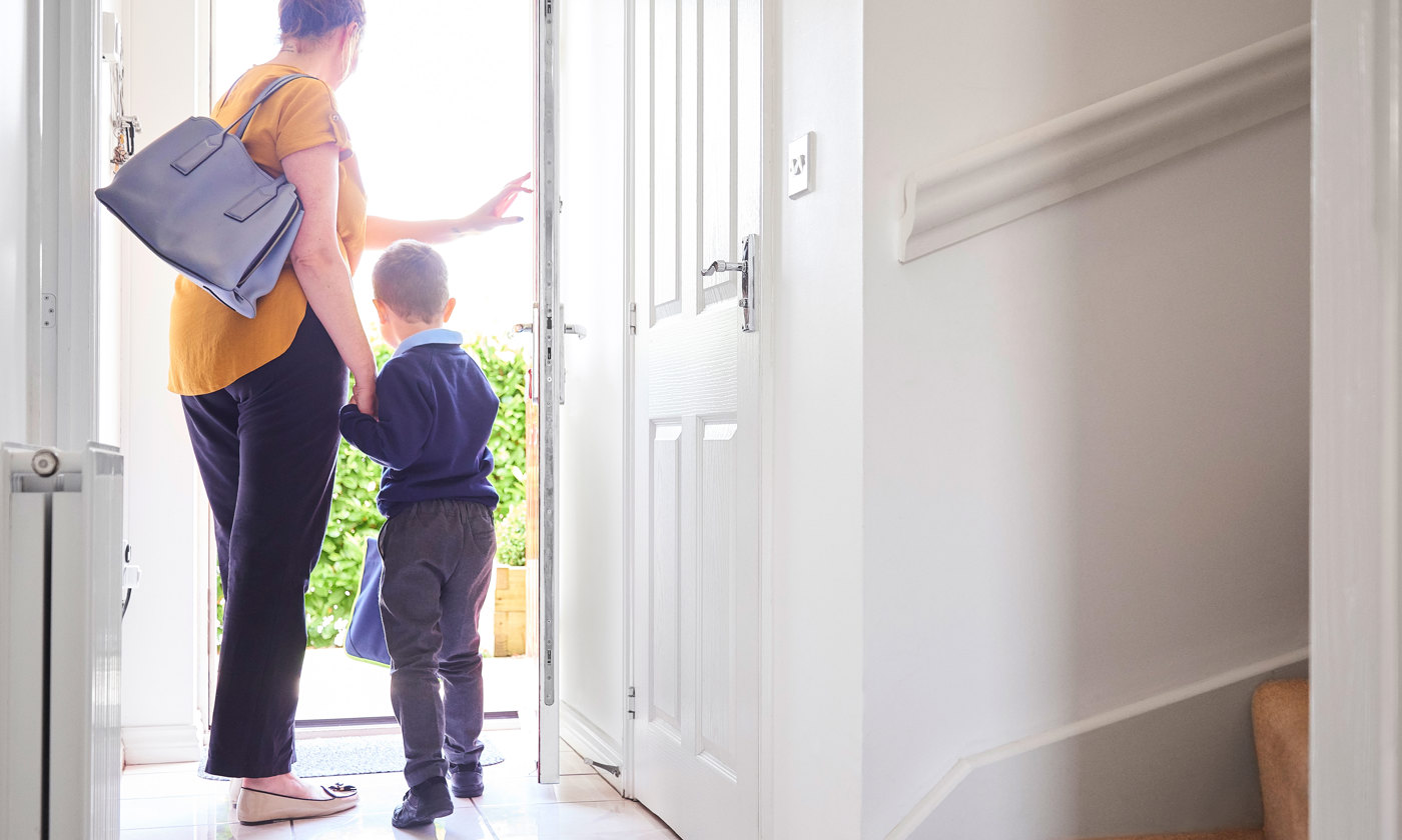A mother and son on their way out for his first day at school