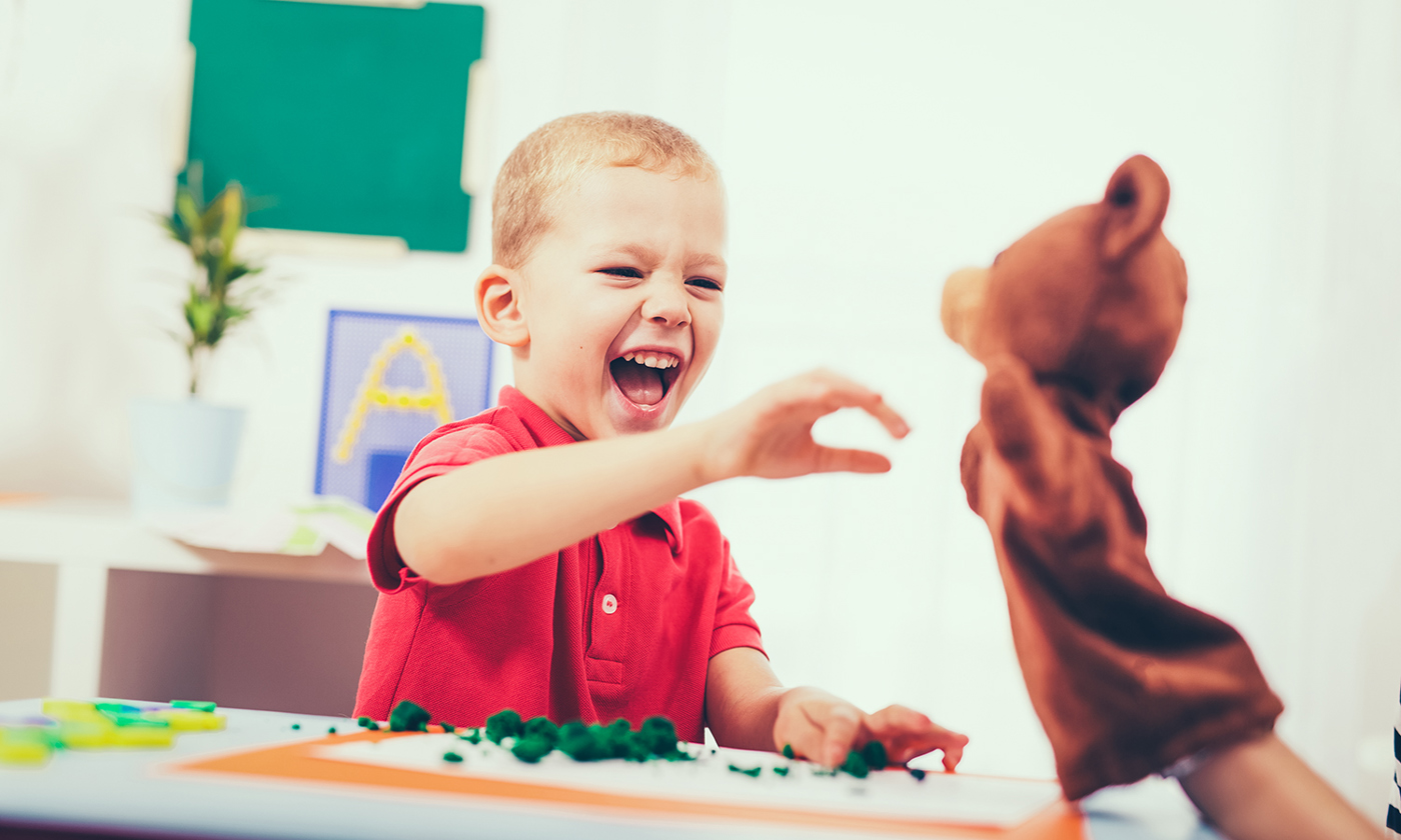 Little boy during lesson with his speech therapist