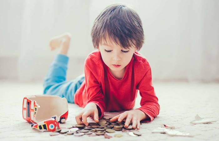 Boy with coins and money box